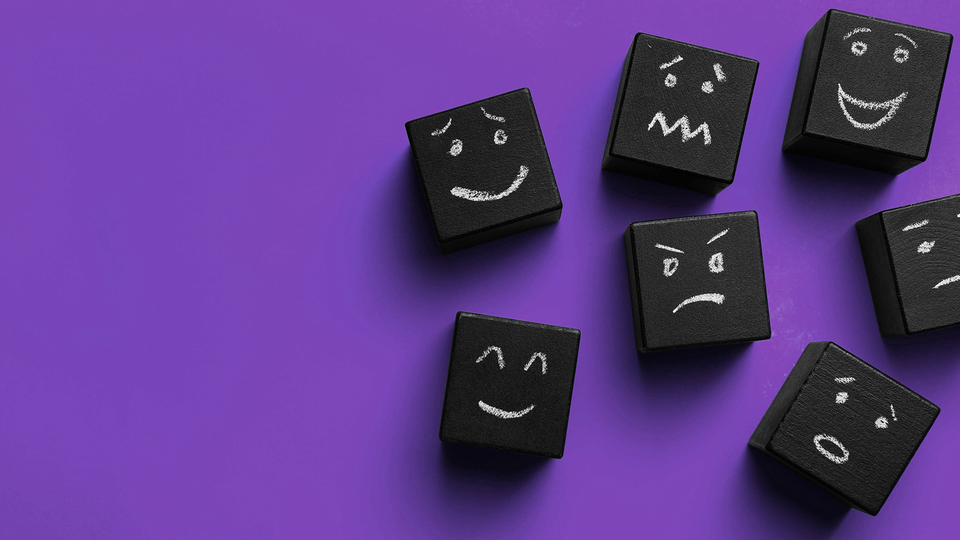 Blocks with chalk drawings representing various emotions