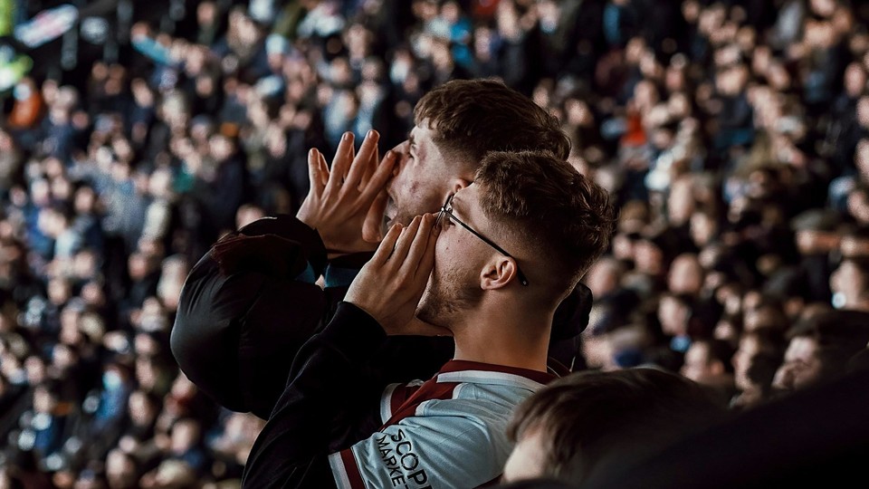 Two men shouting at a spots event