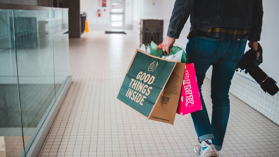 Customer holding shopping bags.