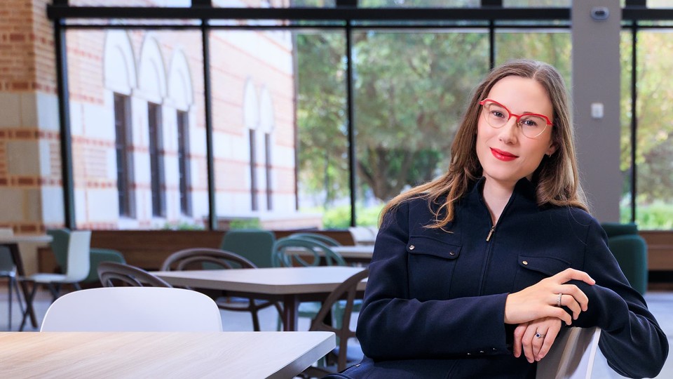 Emily Prinsloo sitting at table in Virani Hall