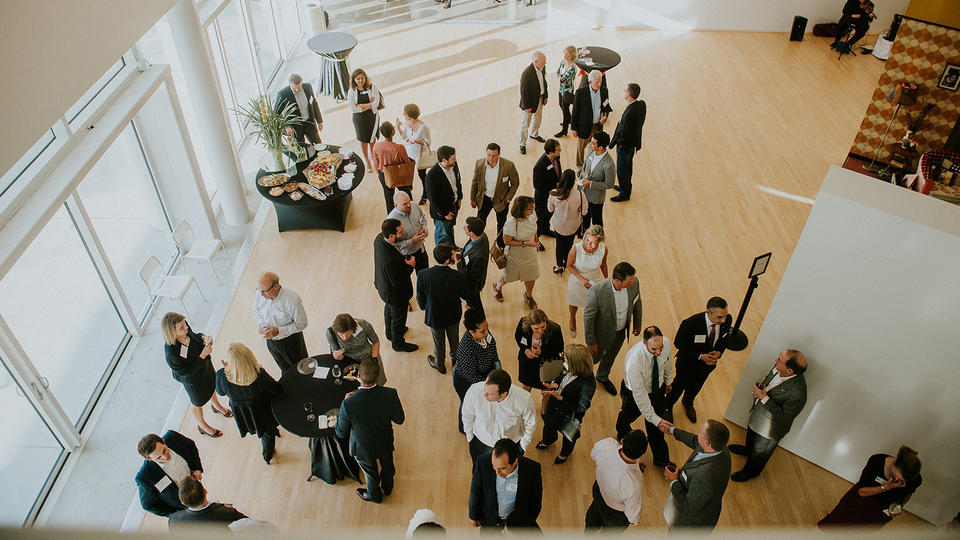 Overhead shot of alumni at a wine reception