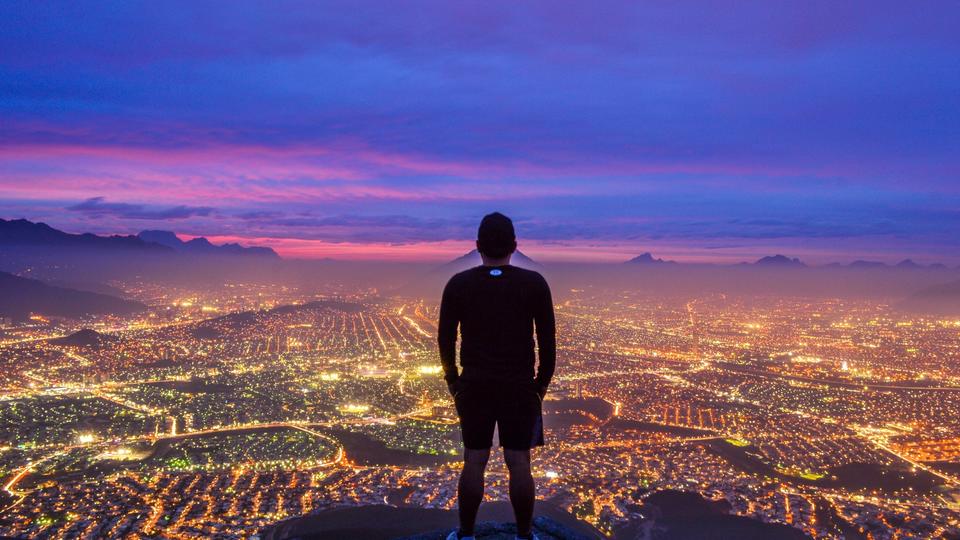 Person looking at a city at night 