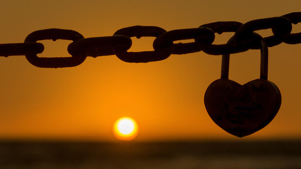 Heart lock on a chain link