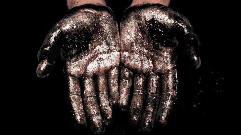 Fuel Spill Oily hands in darkness