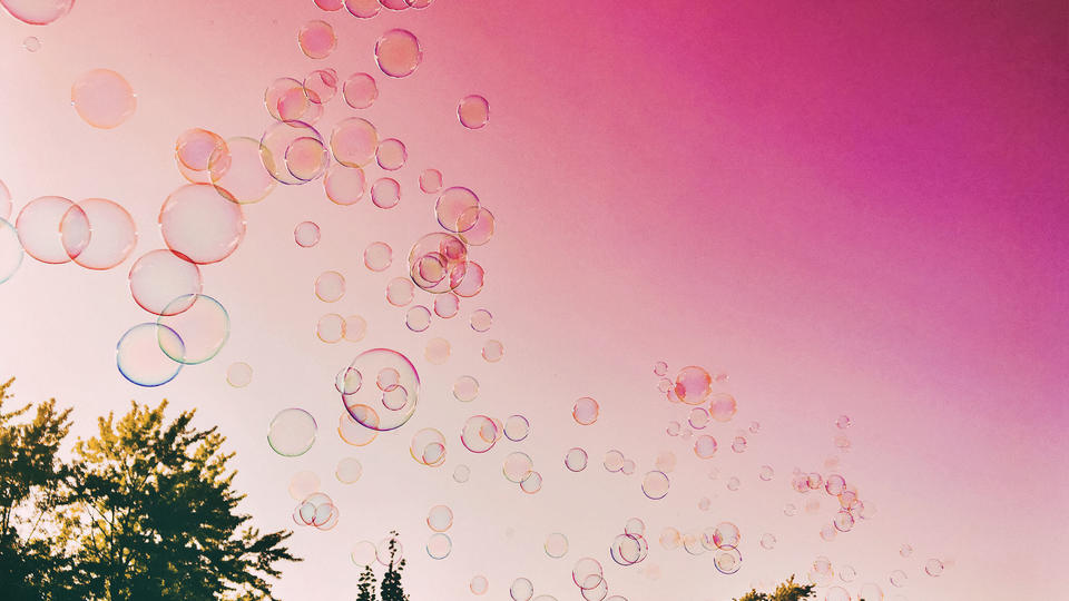 Bubbles floating in the sky at dusk