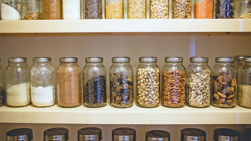 Jars of food on pantry shelves 