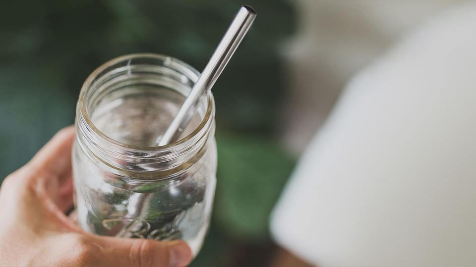 Metal straw in a glass mason jar. 