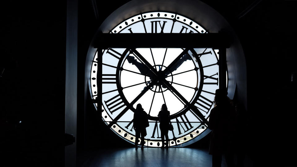 People looking at a clock