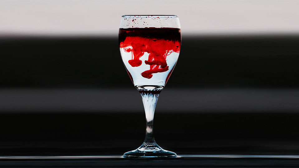 Wine glass filled with red dye and water