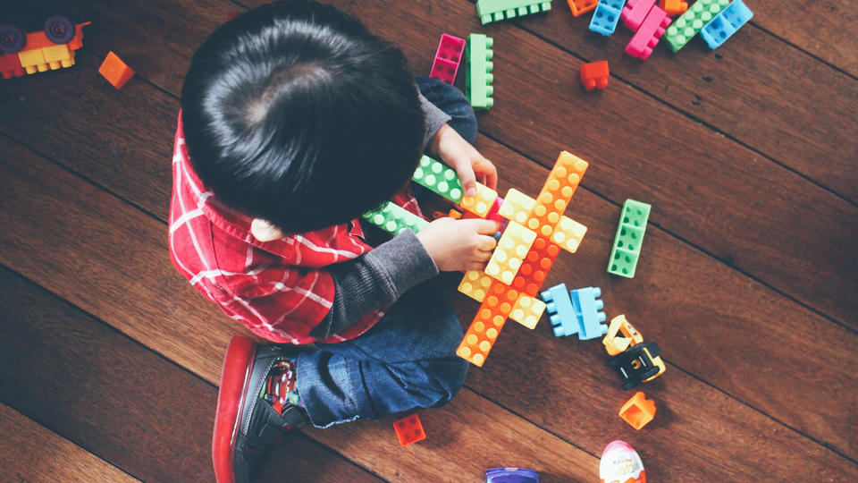 Young boy playing with building blocks. 