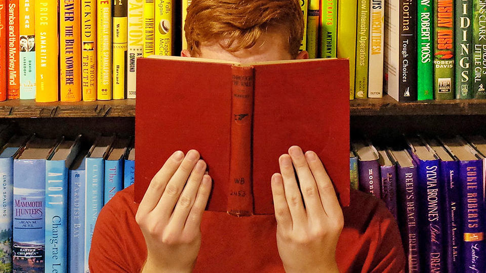 Person holding up a red book