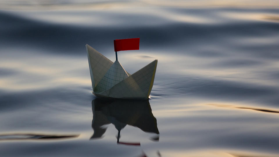 Paper boat floating on water