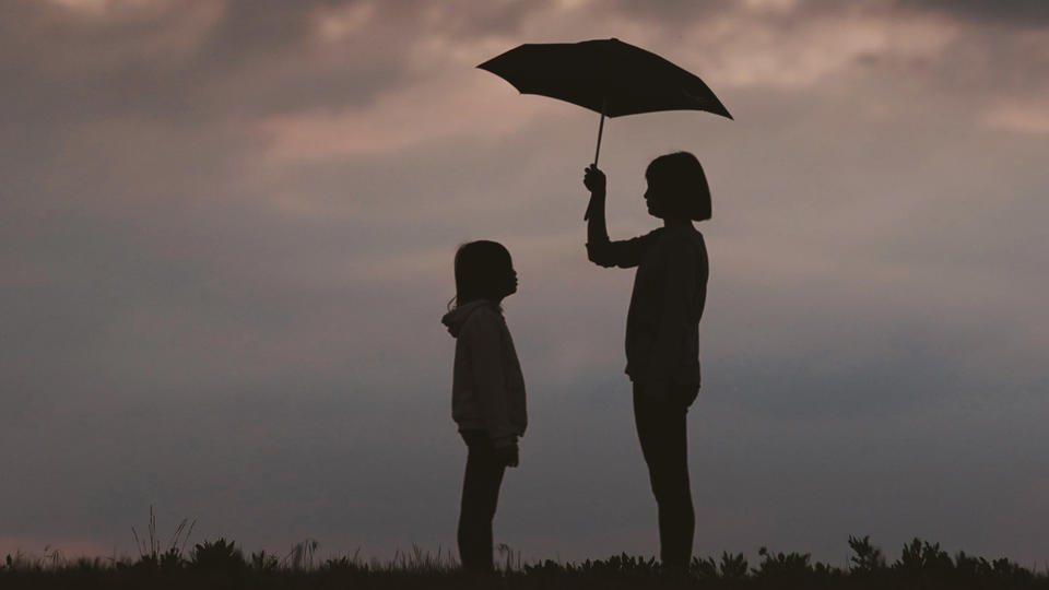 Two people under an umbrella
