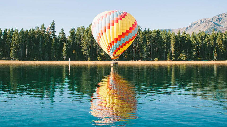 Air balloon near a lake.