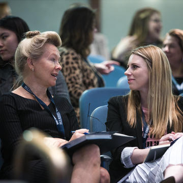 Female MBA student networking with woman