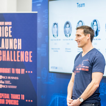 Rice MBA Student standing in entrepreneurial classroom