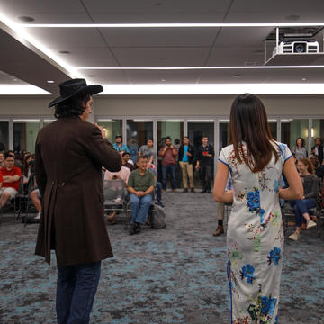 Two students presenting to a crowd