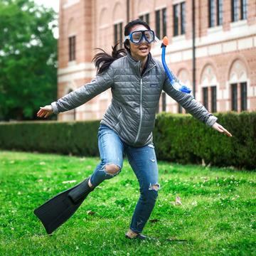 Female student running dressed up for owlympics