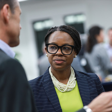 woman in a suit networking at Professional MBA Networking and Leadership