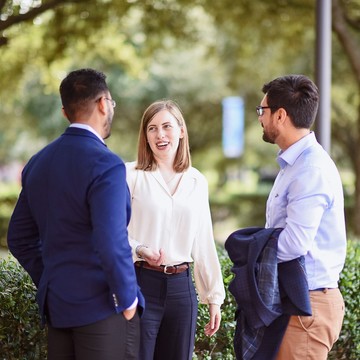 Rice Business professor with MBA students outside McNair hall