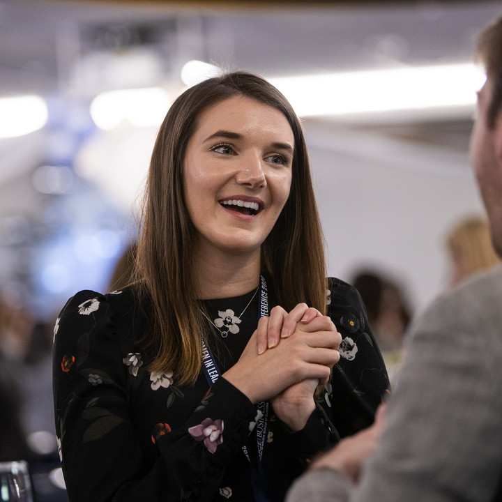 Female Rice MBA student networking with a male during a leadership conference