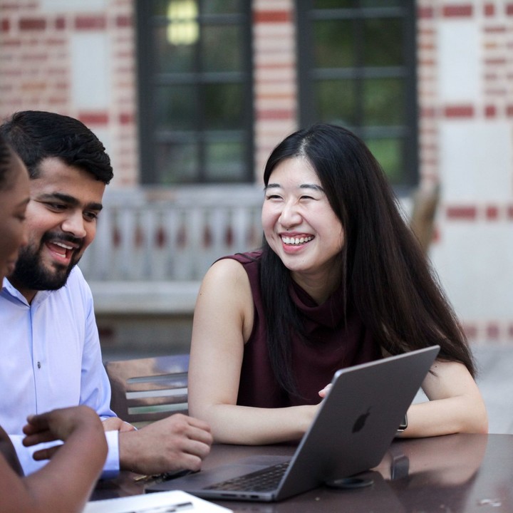 MBA students sitting outside McNair Hall
