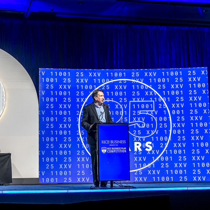 Brad Burke standing on stage at the Rice Business Plan Competition