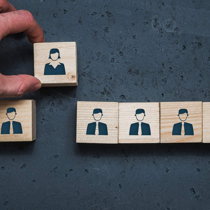 Line of blocks with men icons with a woman icon block removed