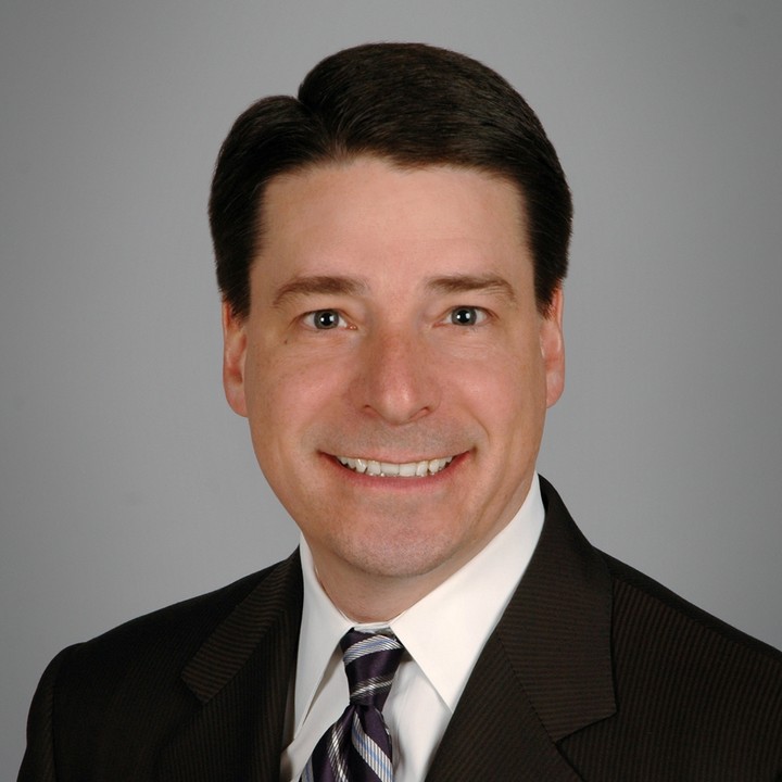 A portrait of Jeff Fleming smiling and wearing a suit. 